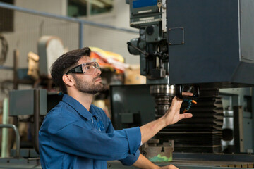 Male engineer worker. Male factory worker working or maintenance the machine in the industrial...