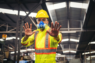 Chemical specialist wear safety uniform and gas mask showing his hands signal no entry chemical...