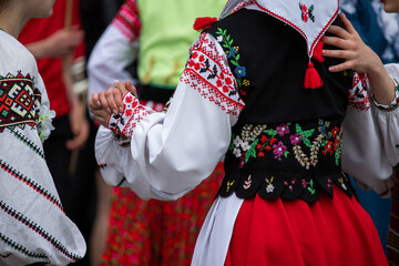 Fototapeta na wymiar Ukrainian national clothing - embroideries. Young people in embroidered shirts dance