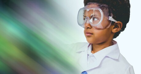 Composition of schoolboy with protective glasses in school laboratory with green motion blur
