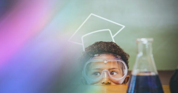 Composition of schoolboy with protective glasses in school laboratory with pink motion blur