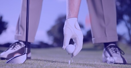 Composition of low section of male golf player with club holding golf ball in golf course
