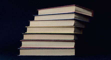A stack of colorful books in the form of a ladder. Color covers. Ladder of Knowledge