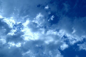 White cumulus clouds against a blue sky. Nice weather and sunshine.