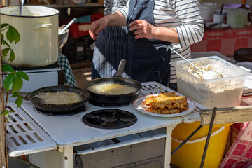Making traditional old style deep fried poteto tocsni rosti hash brown in a hungarian agriculture fair in Kaptalantoti
