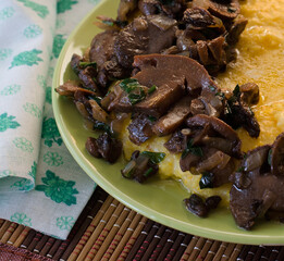 Corn porridge, fried mushrooms with onions on the table.