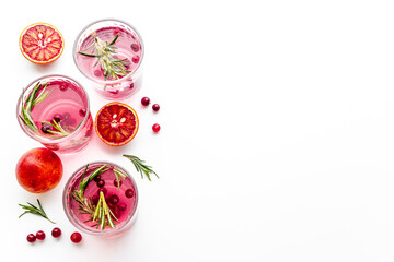 Cold cocktails in glasses with cranberry and blood orange grapefruit