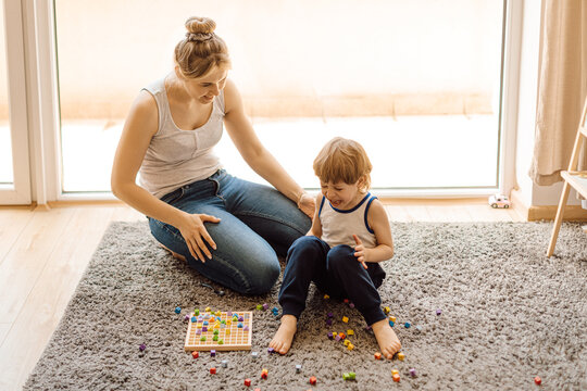 Calmness Of Mother Is Key To Success In Relationships With Young Children. 3 Year Old Boy Is Naughty And Crying. Mom Calms Him Down With Smile.