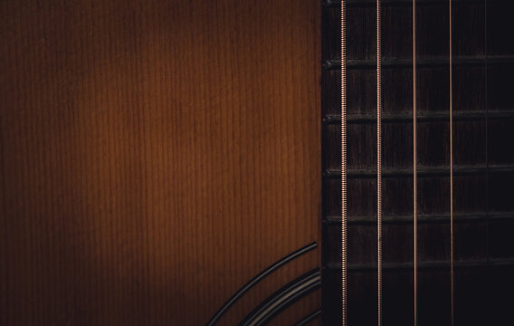 Close up sound board and strings of old acoustic guitar and dark tone vintage filter