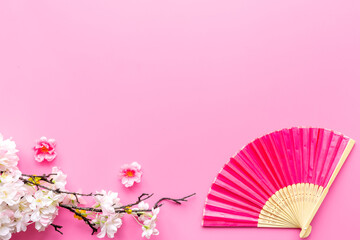 Top view of pink hand fan made of bamboo and paper