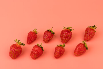 Strawberries on pink background. Strawberries berries pattern. Creative food concept. Flat lay, top view, copy space