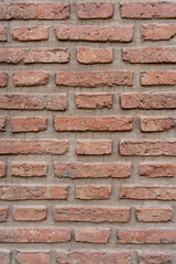 Fototapeta premium Worn exposed brick wall. Vertical shot. Texture background wallpaper