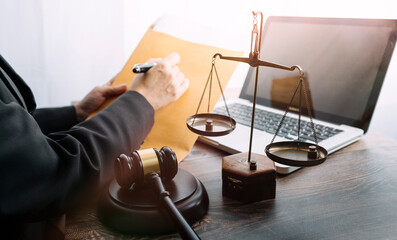 Business and lawyers discussing contract papers with brass scale on desk in office. Law, legal...