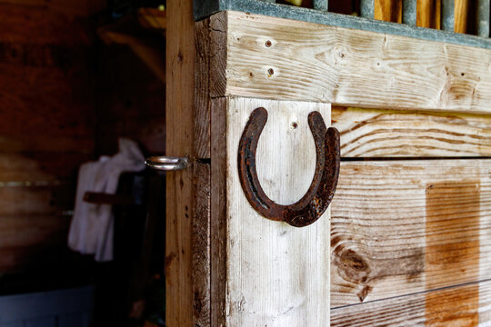 Rusty horseshoe on a barn door