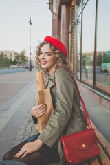 Fototapeta premium Laughing young lovely woman on city street