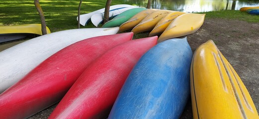 Canoes on the shore waiting for children in the summer camp