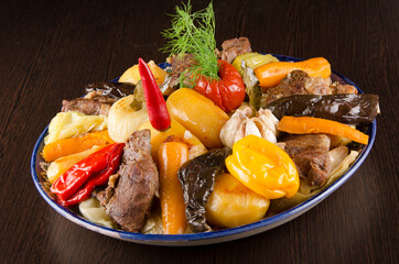 large chunks of stew with whole vegetable stew. peppers, carrots, eggplant, tomatoes, onions, potatoes in big dish
