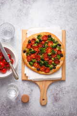 Pizza with basil aromatic oil tomatoes broccoli and olives (ph. Marianna Franchi)