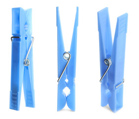 Set with blue plastic clothespins on white background