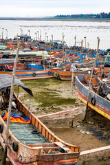 Fototapeta na wymiar Close-up of fishing boats docked on the beach by the sea, tool boats and fishing boats