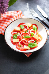 tomato salad veggie vegetable, cheese, onion diet vitamin on the table healthy food keto or paleo diet meal snack copy space food background rustic. top view vegan or vegetarian food