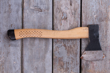 Axe on rustic wooden boards.