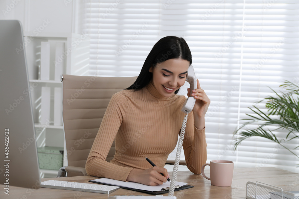 Poster Secretary talking on phone at wooden table in office