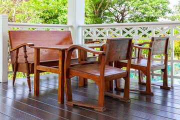 Antique style dark brown wooden living room set on a wooden patio