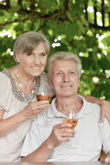 Old couple drinking wine