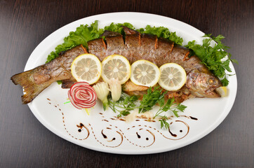 fried fish in a salad with lemon, beautifully served in a restaurant