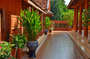 Fototapeta na wymiar Beautiful ornament plants on balcony of beautiful teak house