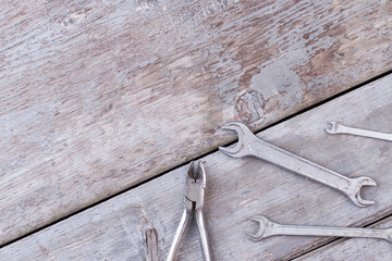 Construction instruments on rustic wooden background.