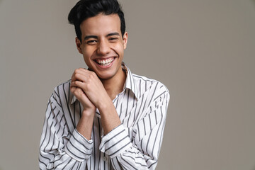 Fototapeta premium Brunette hispanic man in shirt laughing and looking at camera