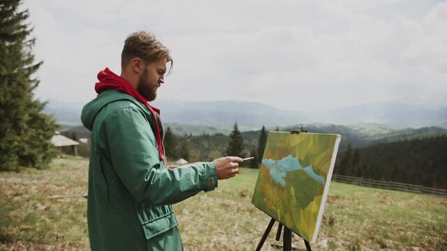 A family of artists creates a painting with a magnificent view of the mountains.Painting concept