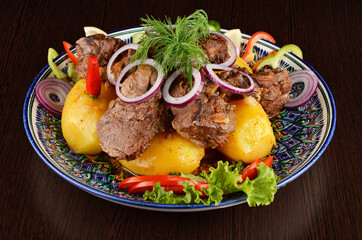 stew with potatoes, garnish with onion rings, pepper, lettuce and dill, Asian cuisine