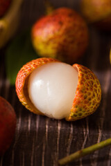 litchi, lichee, lychee, or Litchi chinensis on old rustic wood background