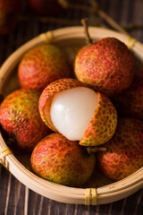 litchi, lichee, lychee, or Litchi chinensis on old rustic wood background
