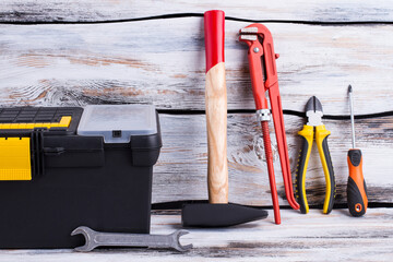 Different repair tools on wooden background.