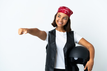 Young woman holding a motorcycle helmet isolated on white giving a thumbs up gesture