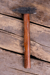 Top view of hammer with wooden handle.