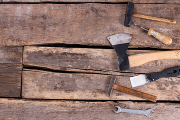 Different working tools on wooden boards background.