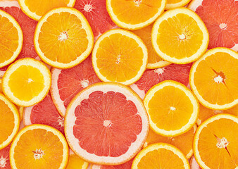 Bright summer background with slices of oranges and grapefruits 