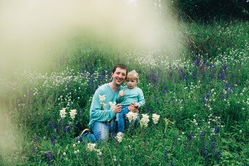daughter with father in a field with flowers. international day of men. great father. destruction...
