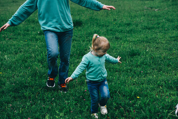 father runs with daughter in a green field. international day of men. great father. destruction of...