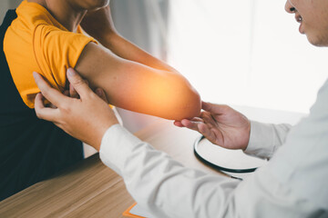 Male doctor examining a patient who has been injured or has pain in the arm, Concept of treatment of the patient Primary nursing care Expert doctor Living health problems Better quality of life