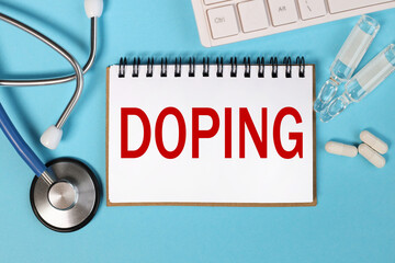 DOPING. inscription on white notepad paper near stethoscope and white keyboard