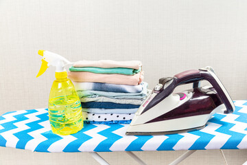 Electric clothes iron on the ironing board.