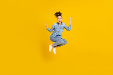Fototapeta na wymiar Full length body size photo young pretty girl jumping up showing heavy metal sign isolated vivid yellow color background