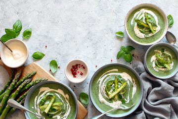 Asparagus and potato cream soup on light background. Top view with copy space. Healthy food.