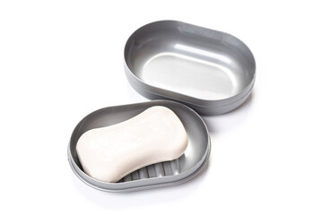 Travel soap in plastic soap dish isolated on white background